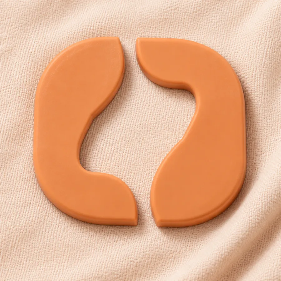 The Hood Name mark, two apricot forms framing an open centre, pressed into peach cloth.